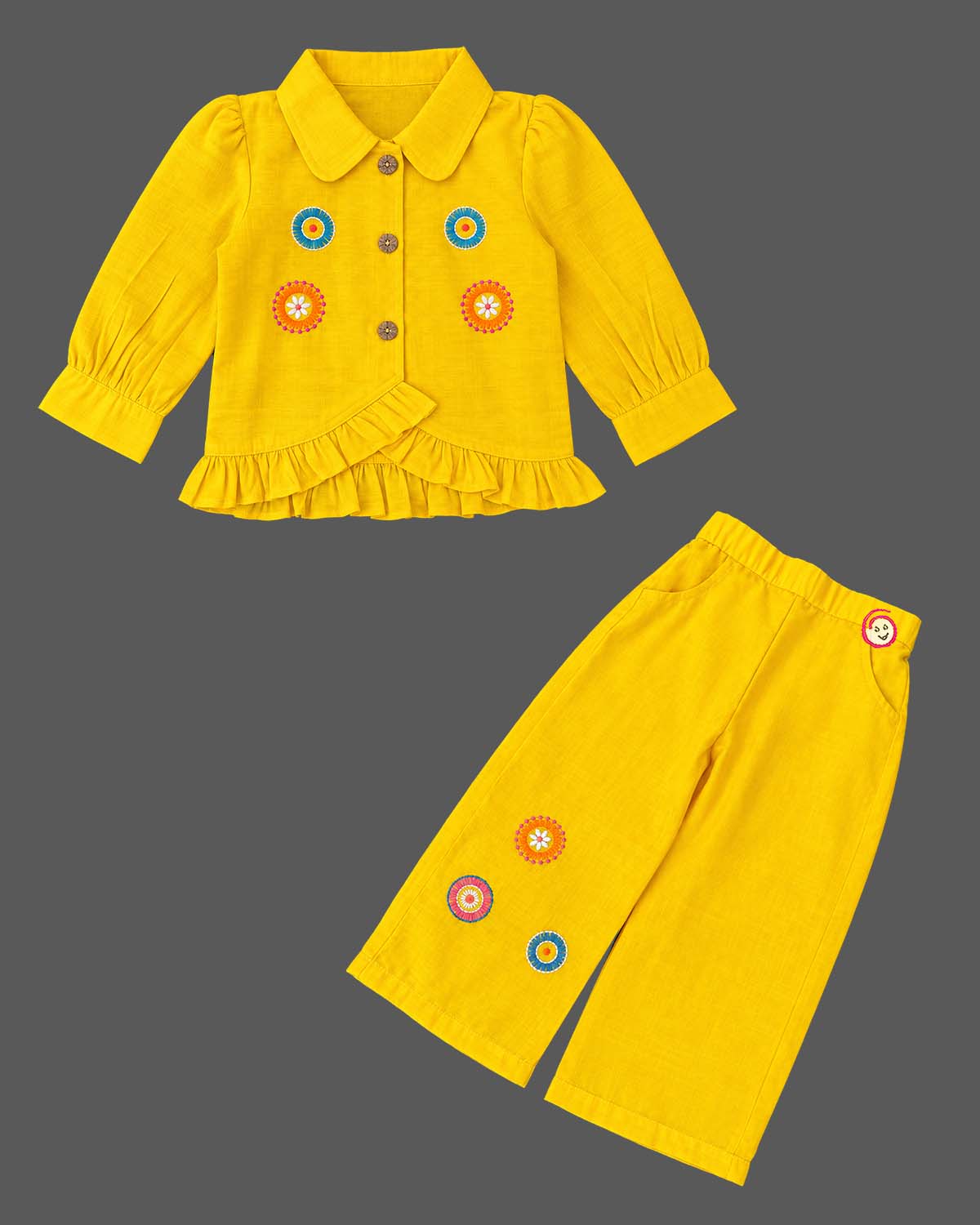 Embroidered peplum top and wide-leg pants co-ord set representing a kurti for kids with front button closures.