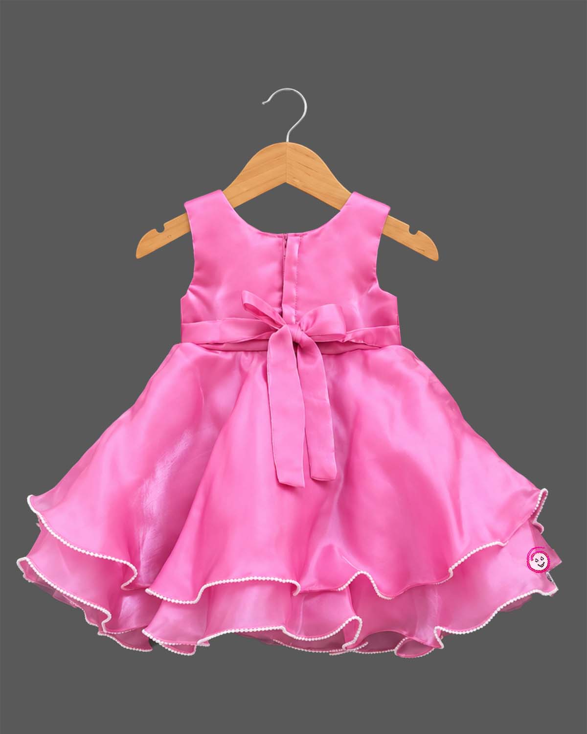 Sleeveless satin tiered party frock featuring three beaded rosettes at the waist and scalloped layered hem
