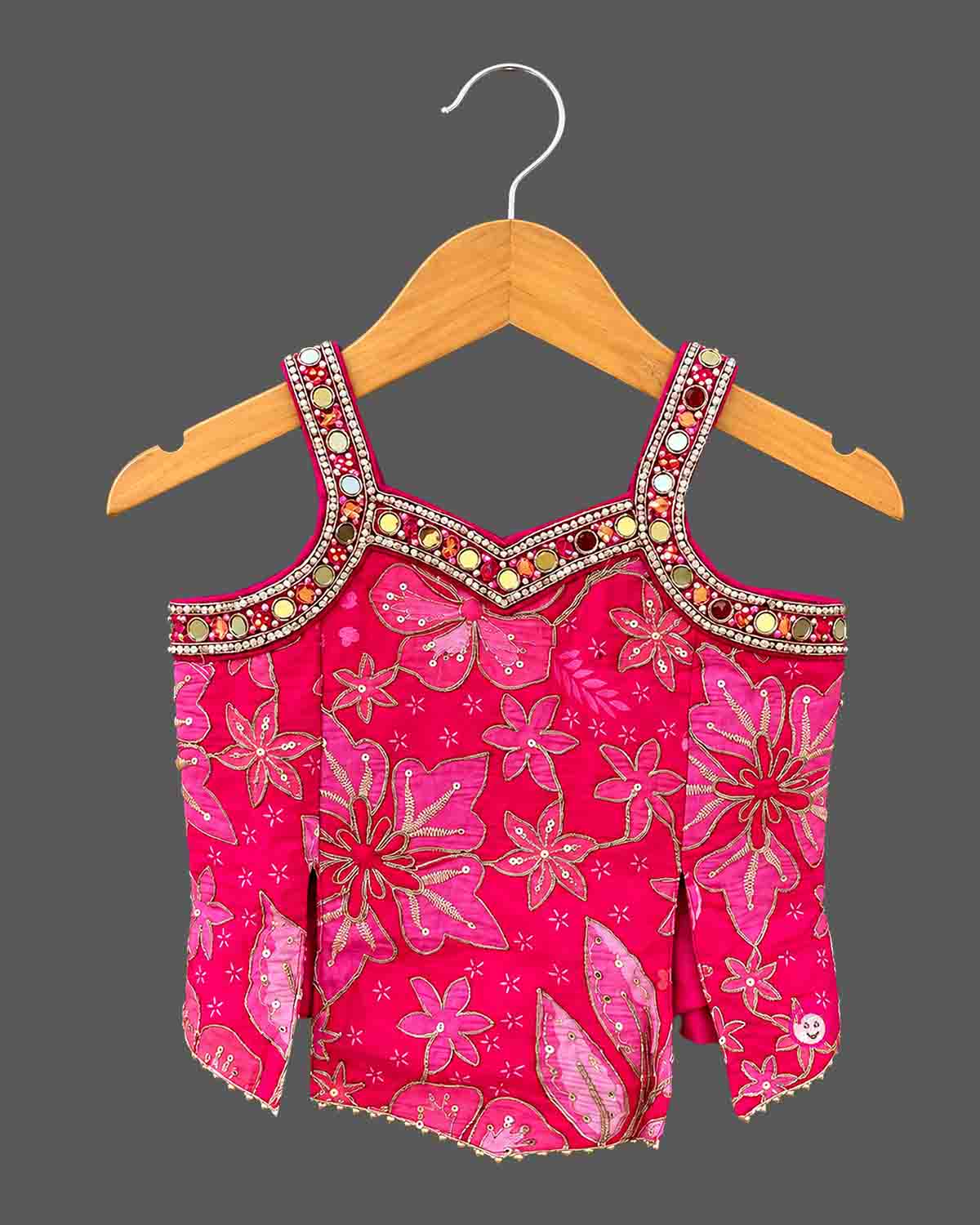 Kids sharara set featuring strappy embroidered top with mirror work trim and wide flared palazzo pants.