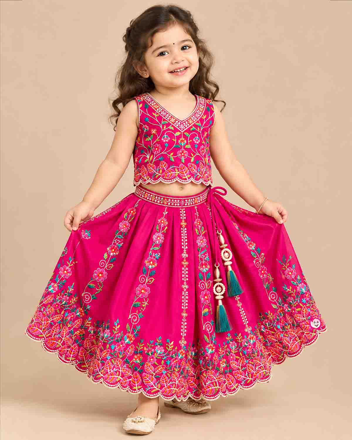 Detailed view of sleeveless embroidered lehenga choli for kids featuring scalloped floral hems.