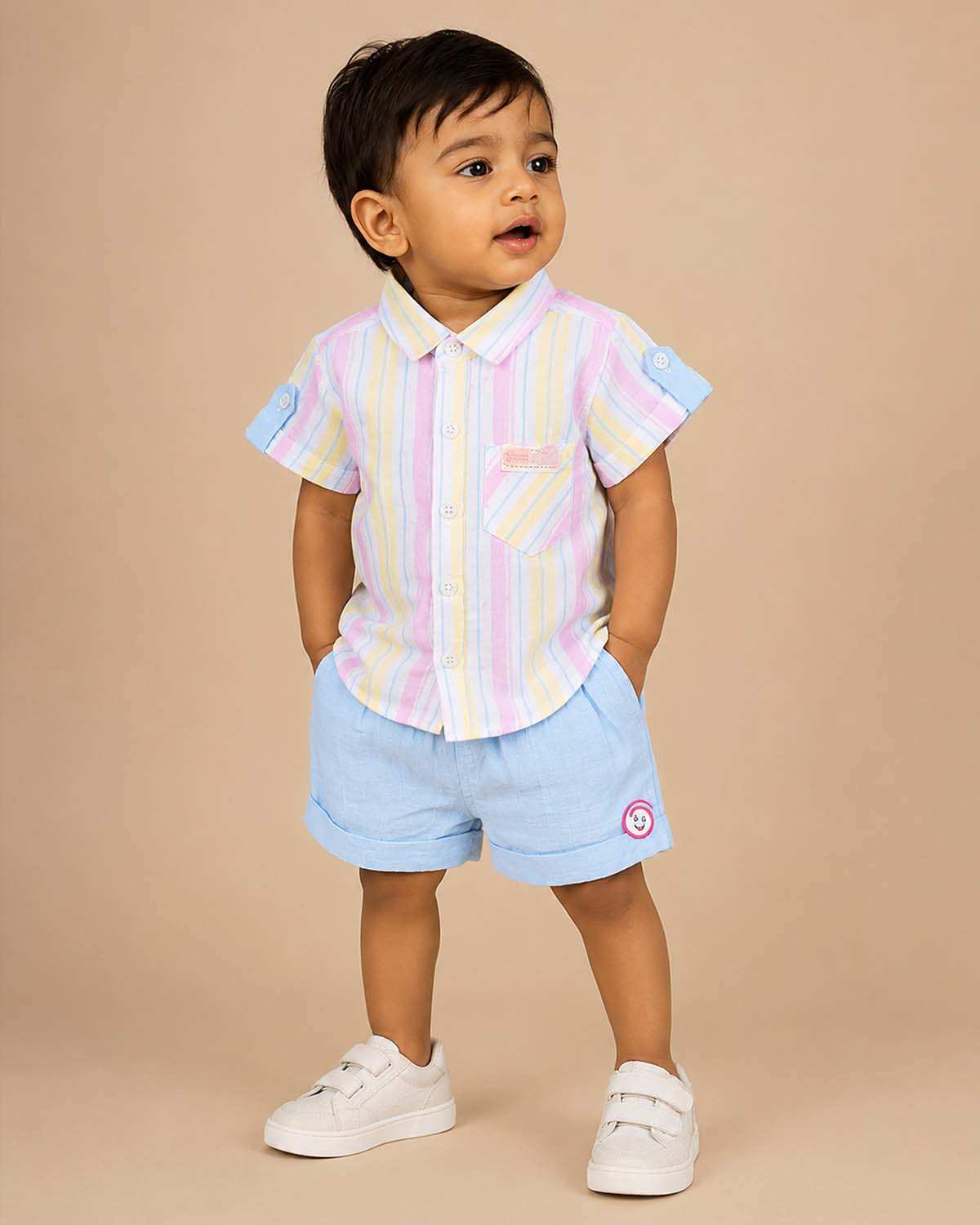 Boys 2-piece cotton casual set featuring a short-sleeve pastel pink, yellow, and blue striped shirt with matching solid sky blue elastic-waist shorts