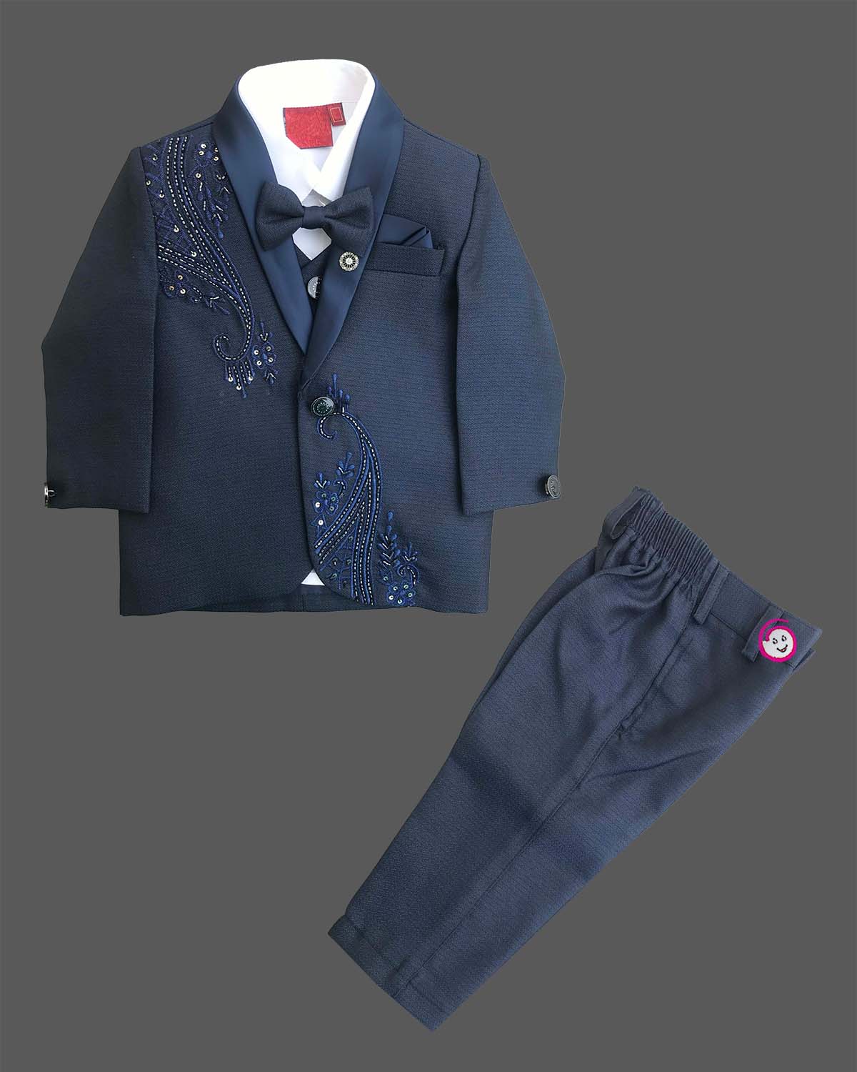 Boys navy blue formal tuxedo blazer with sequin embellishments, satin , bow tie, brooch pin, paired with elastic waist formal pant