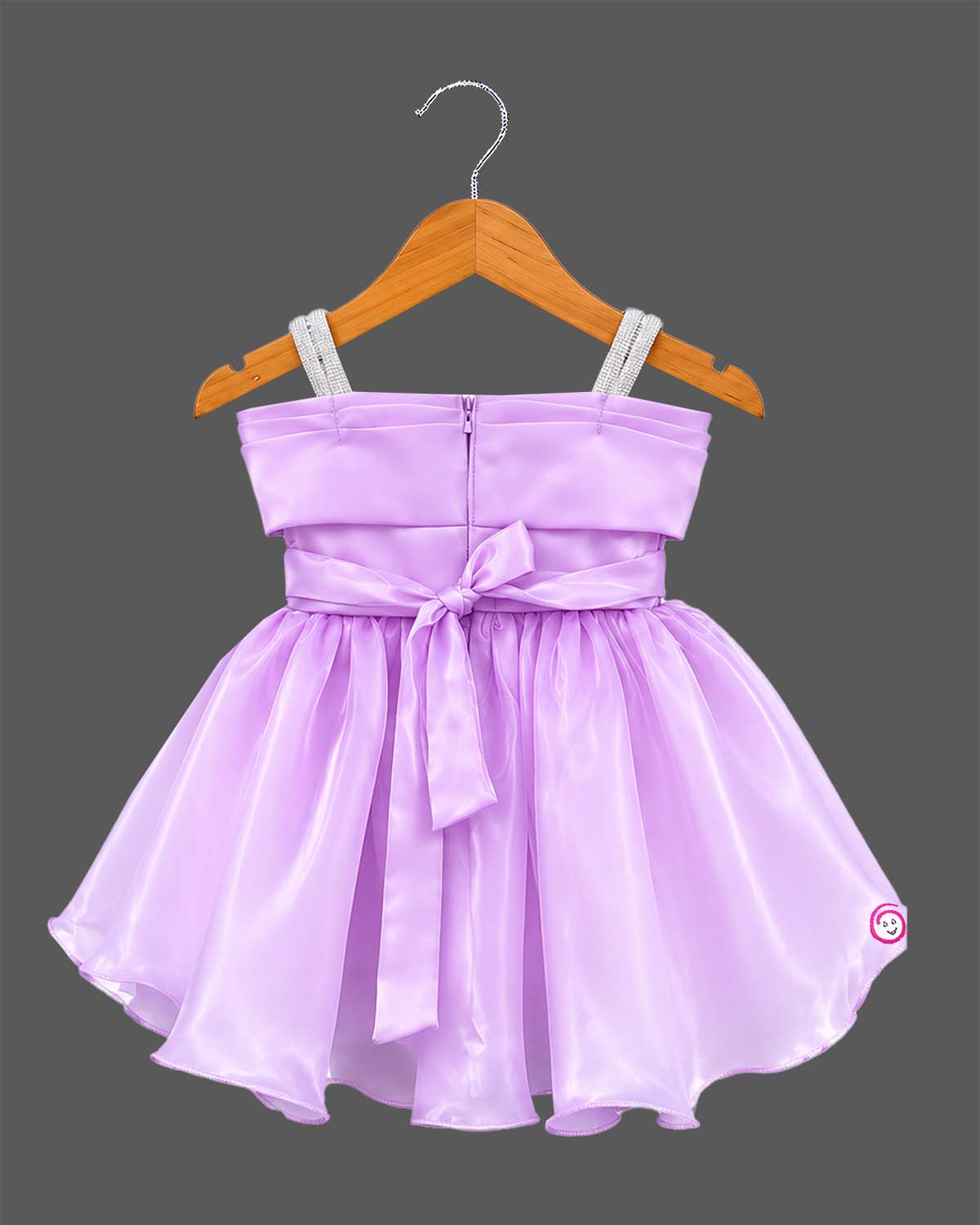 Lavender satin and organza party frock for baby girl featuring oversized side bow, rhinestone shoulder straps, and crystal brooch for birthday and wedding celebrations