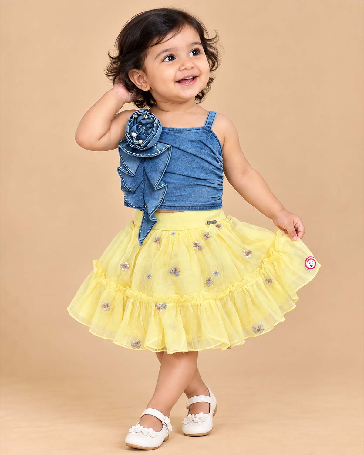 Girls blue denim strappy top with ruffle flower and yellow net embroidered skirt set
