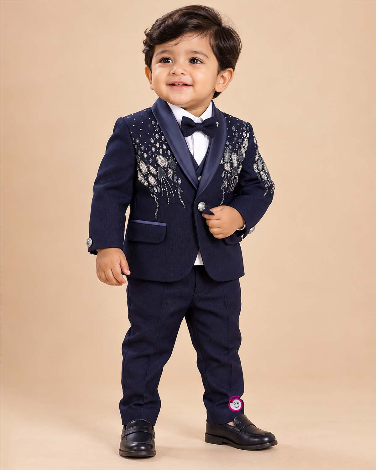 Boys formal tuxedo suit set featuring bead embellished blazer with bowtie and pant.