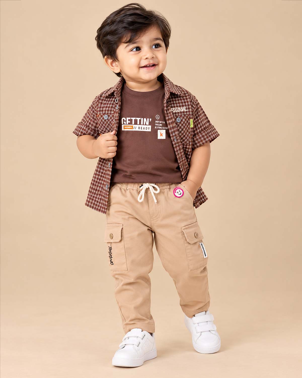Toddler wearing button-down shirt and pant styled as a kids wedding dress.