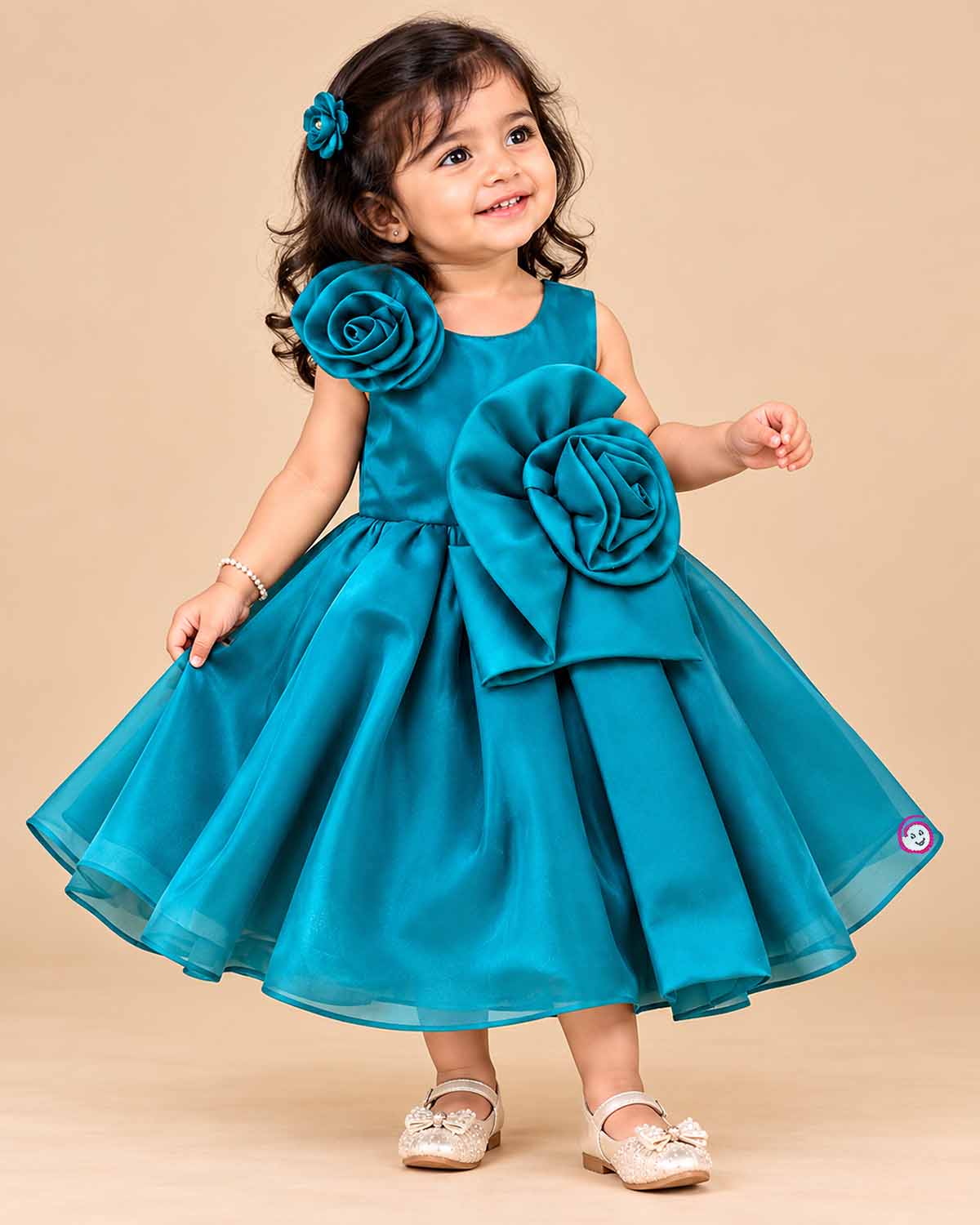 Teal blue satin party frock for toddler girls with large floral accents on shoulder and waist