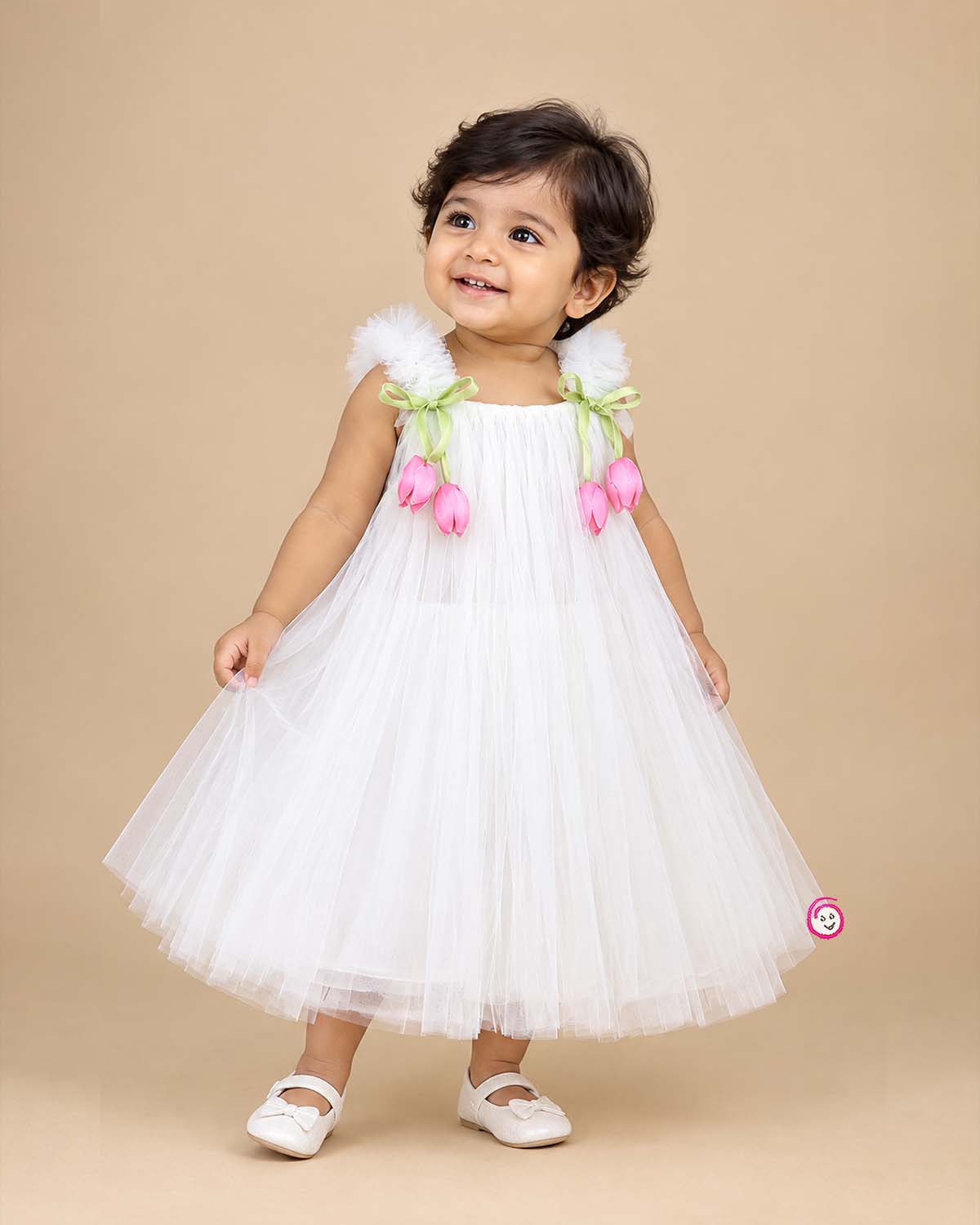Off white net party frock with pink tulip floral accents and strap bows for girls