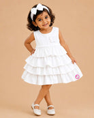 White tiered ruffled baby girl party wear frock with butterfly applique for birthdays, weddings, and special occasions