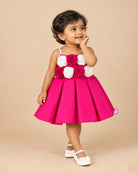 Hot pink satin party frock for girls with white and magenta floral rose appliques and embellished shoulder straps