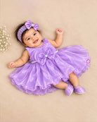 Infant satin party frock with statement bow and pearl neckline for baby girls