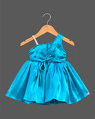 Silk frocks for baby girl with asymmetrical one-shoulder cut and beaded floral applique.