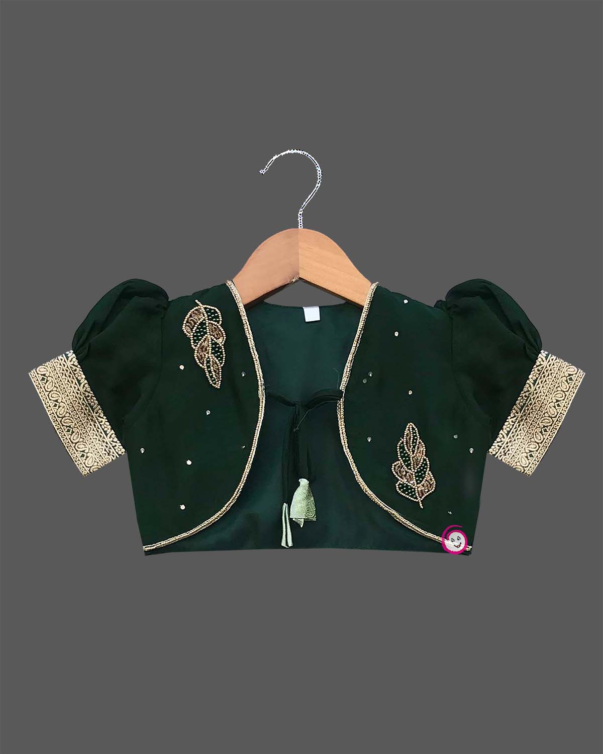 Infant  cotton silk frock in pastel mint green and dark bottle green with attached jacket style design, leaf embroidery, front tie-up tassels, and a traditional gold zari border