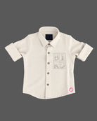 Collared button-down shirt with chest pocket embellishment featured in party wear for boys