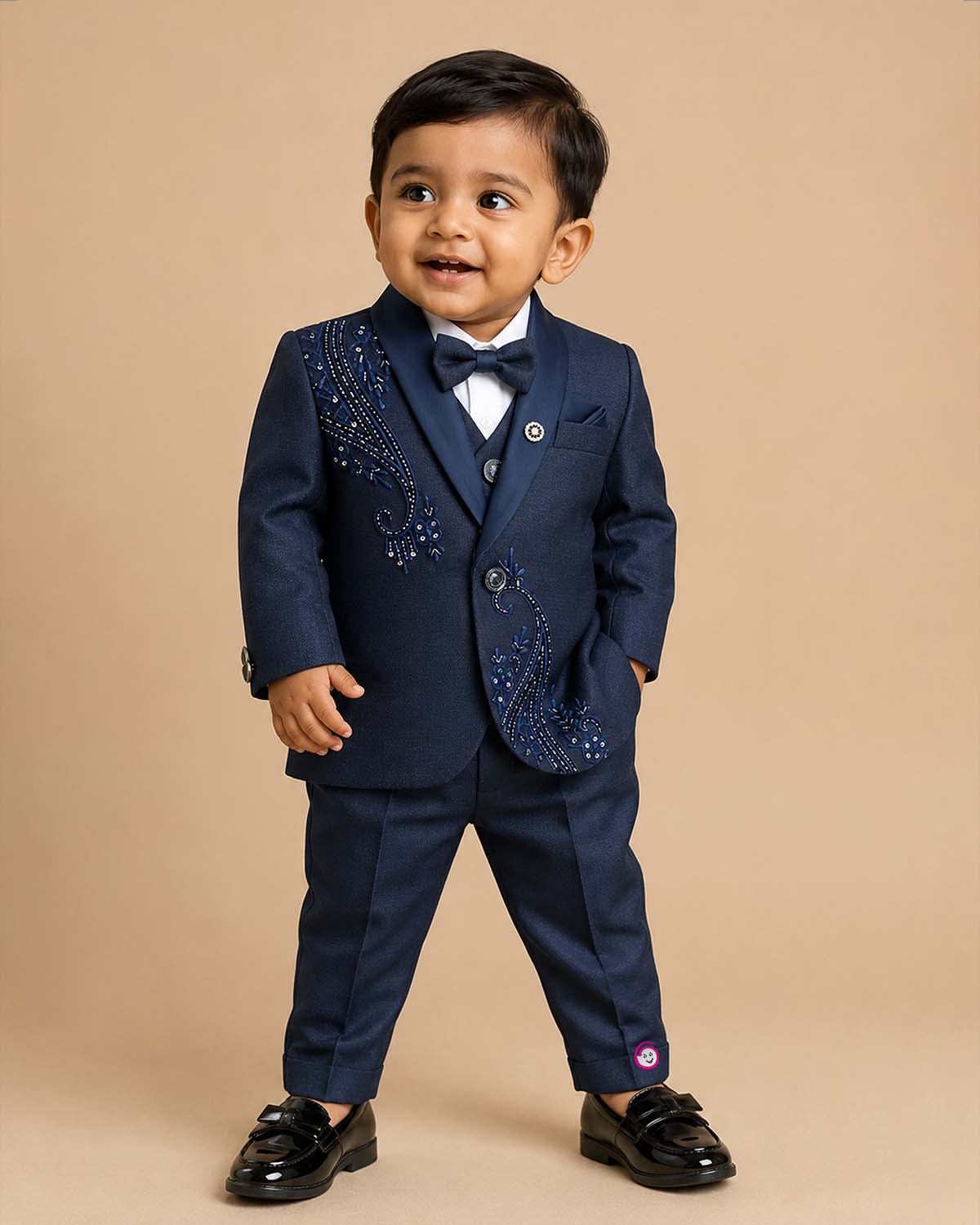 Boys navy blue formal tuxedo blazer with sequin embellishments, satin , bow tie, brooch pin, paired with elastic waist formal pant