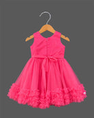 Sleeveless pleated tulle frock for girls with flower applique and ruffled hemline on hanger