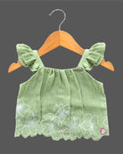 Sleeveless ruffle strap top paired with a flared embroidered skirt for a young fashionista.