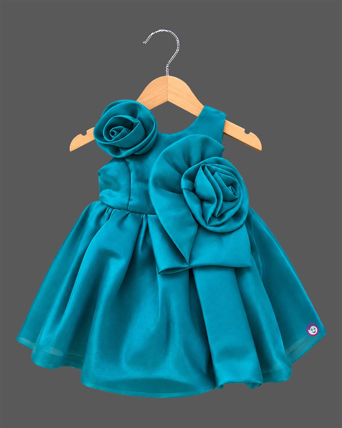Teal blue satin party frock for toddler girls with large floral accents on shoulder and waist