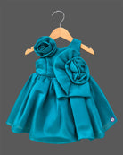 Teal blue satin party frock for toddler girls with large floral accents on shoulder and waist