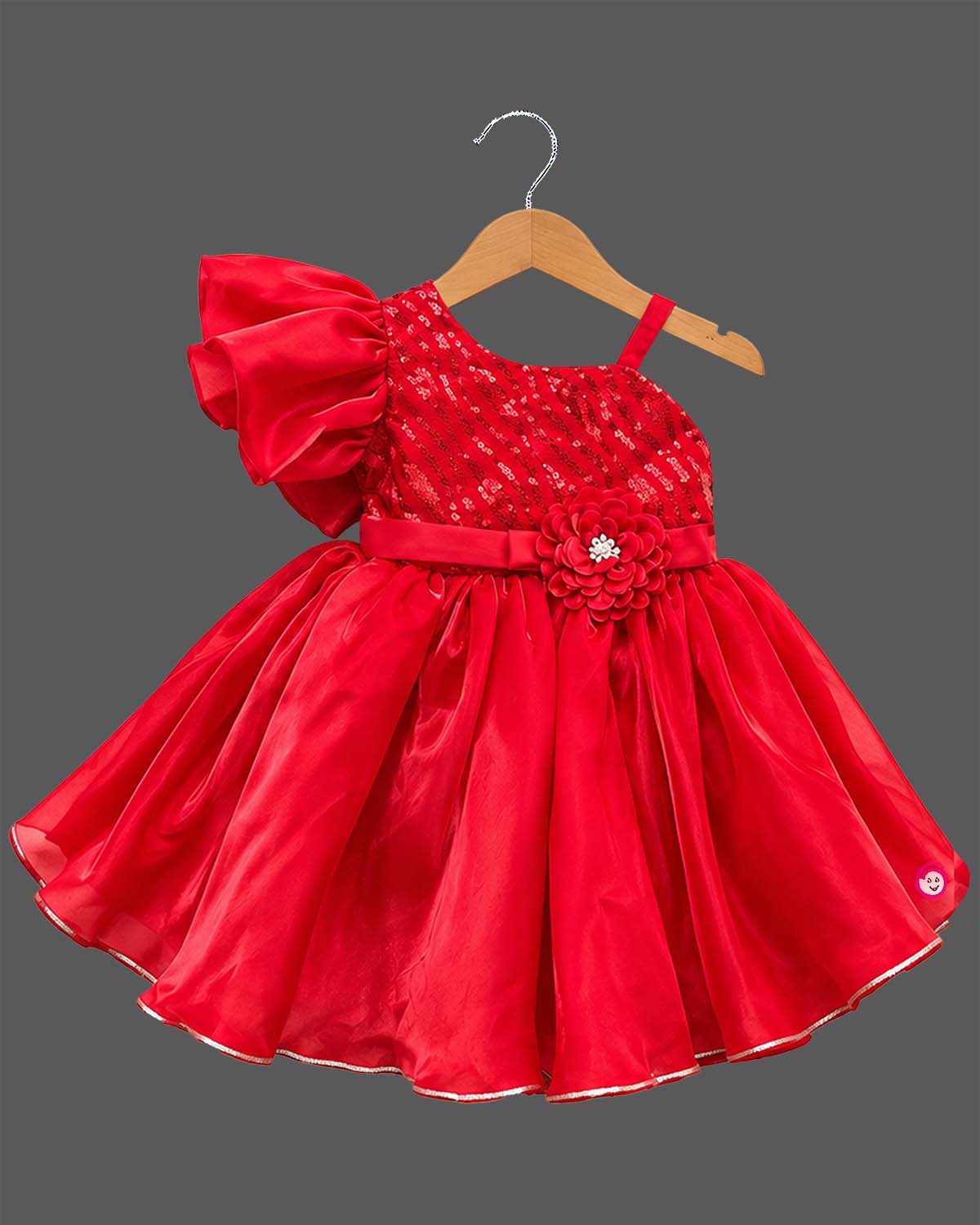 Girls sequin one shoulder frock with dramatic ruffle sleeve, floral waist applique, and flared layered skirt.