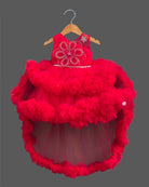 Sleeveless net ruffle baby party wear dress with high-low hemline and floral chest applique.
