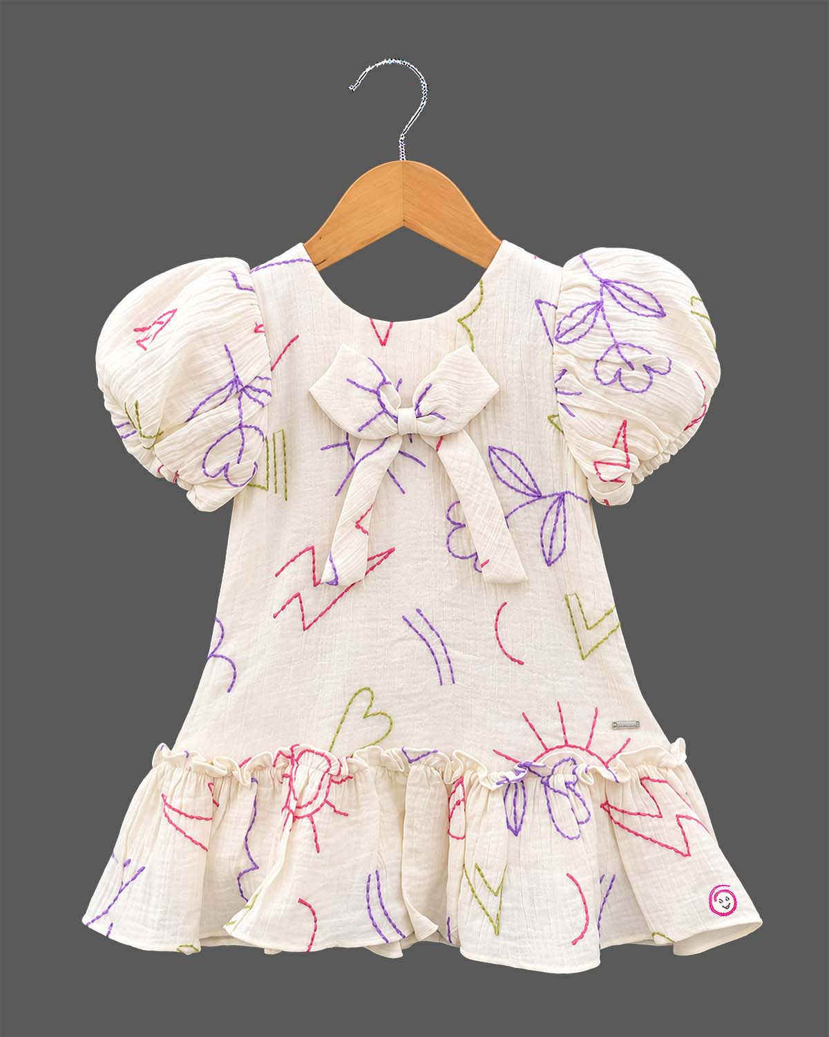 Girls casual printed frock with puff sleeves, front bow accent, and ruffled hem