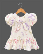 Girls casual printed frock with puff sleeves, front bow accent, and ruffled hem