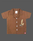 Infant casual outfit with button-down shirt and elastic waistband shorts for play.