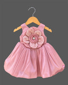 Dusty rose pink toddler net party frock featuring a large floral applique and sleeveless design for girls.