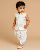 Boys off-white silk ethnic kurta jacket with gold elephant embroidery and mandarin collar paired with matching elastic waist dhoti pant