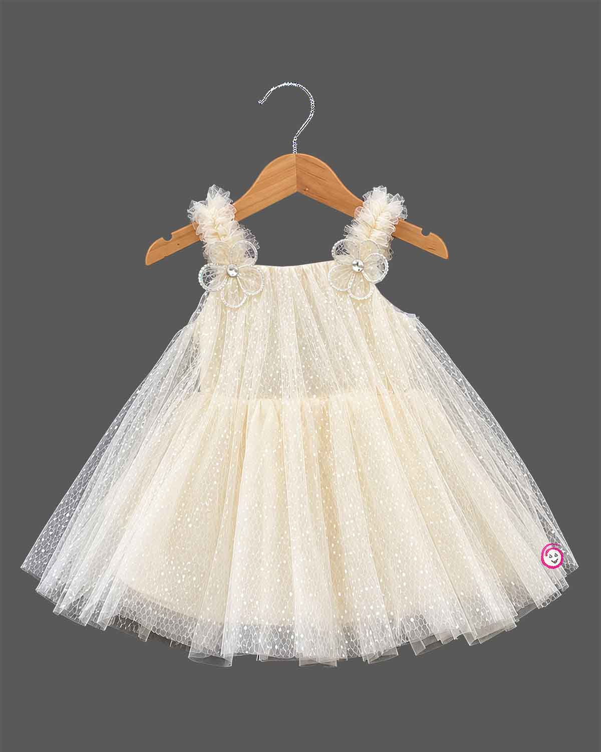 Cream Little Girl Tulle Party Frock with Polka Dots, Flower Details, and Square Neck on Hanger.