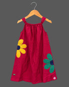 Baby girl lehenga style sleeveless dress with large floral appliques, soft textured weave, and flared silhouette.