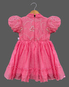 Pink georgette frock with white embroidery and puff sleeves for baby girls