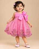 Girls sequin embellished A-line frock with large front satin bow, illusion mesh straps, and pearl beaded trim.