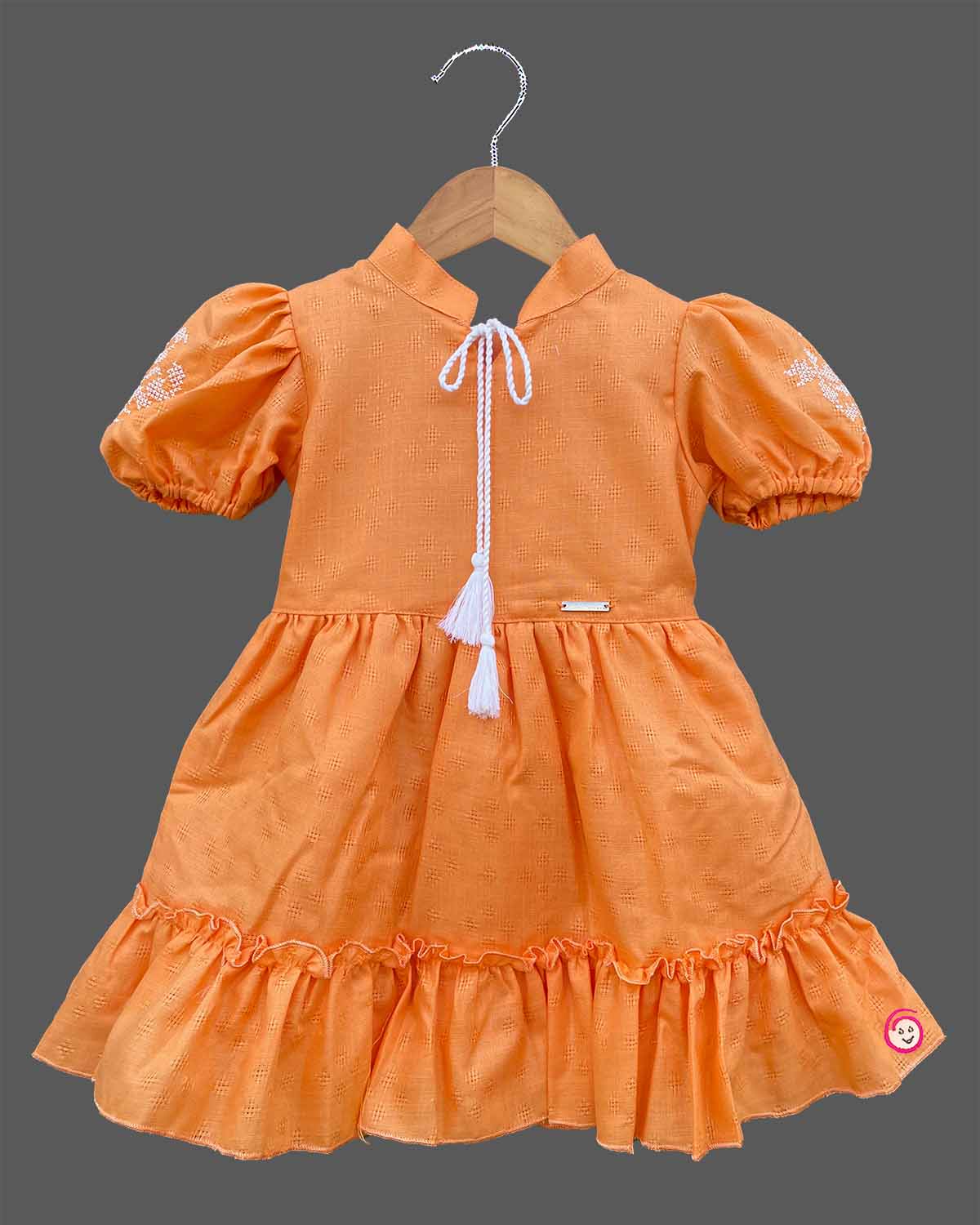 Orange cotton baby girl frock with puff sleeve and white embroidery detail