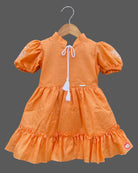 Orange cotton baby girl frock with puff sleeve and white embroidery detail