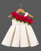 Girls one-shoulder box pleated party frock with 3D floral applique trim along neckline.