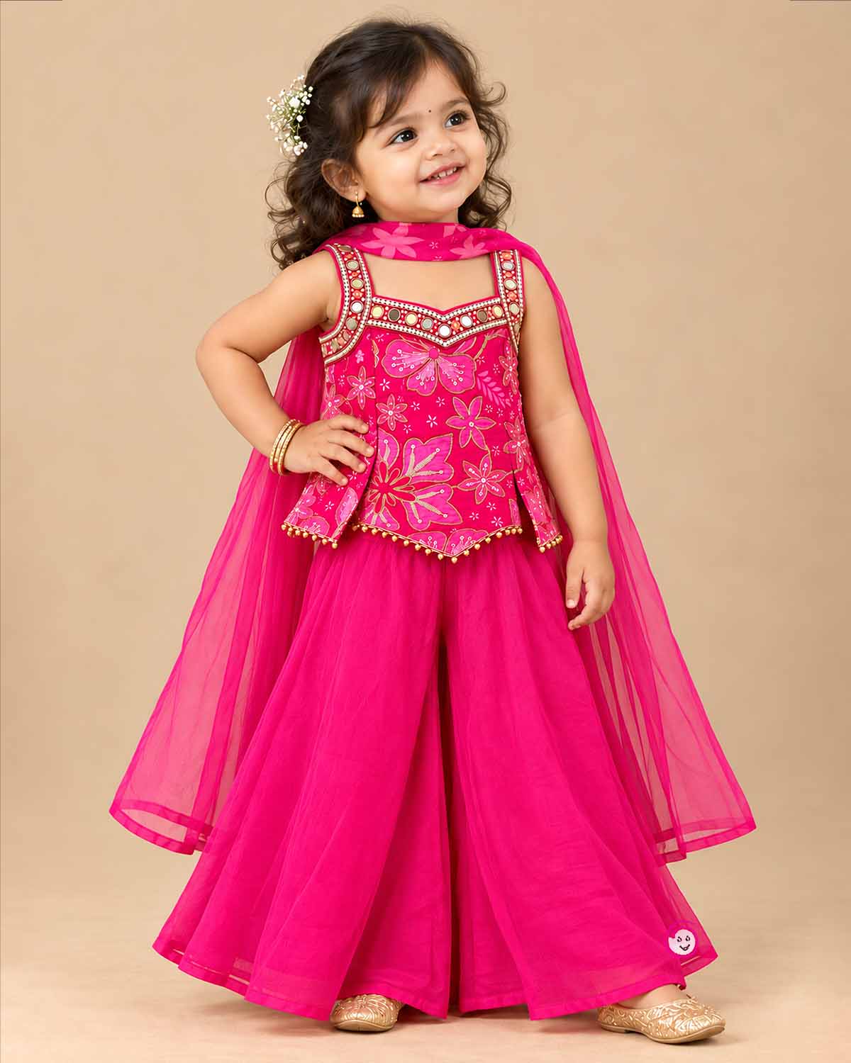 Kids sharara set featuring strappy embroidered top with mirror work trim and wide flared palazzo pants.