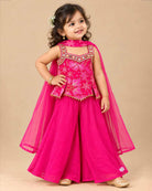 Kids sharara set featuring strappy embroidered top with mirror work trim and wide flared palazzo pants.