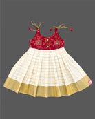Little princess wearing traditional Kasavu pleated frock with floral brocade bodice for festive celebrations