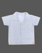 A matching casual shirt and shorts duo for young boys featuring an all-over patterned design and a comfortable elastic waistband.
