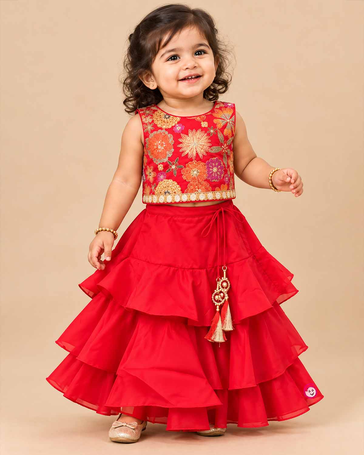 Girls floral embroidered sleeveless choli paired with a tiered ruffled skirt and tassel drawstring accent.