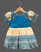 Kids silk ethnic frock featuring floral hand embroidery and woven zari border for traditional parties