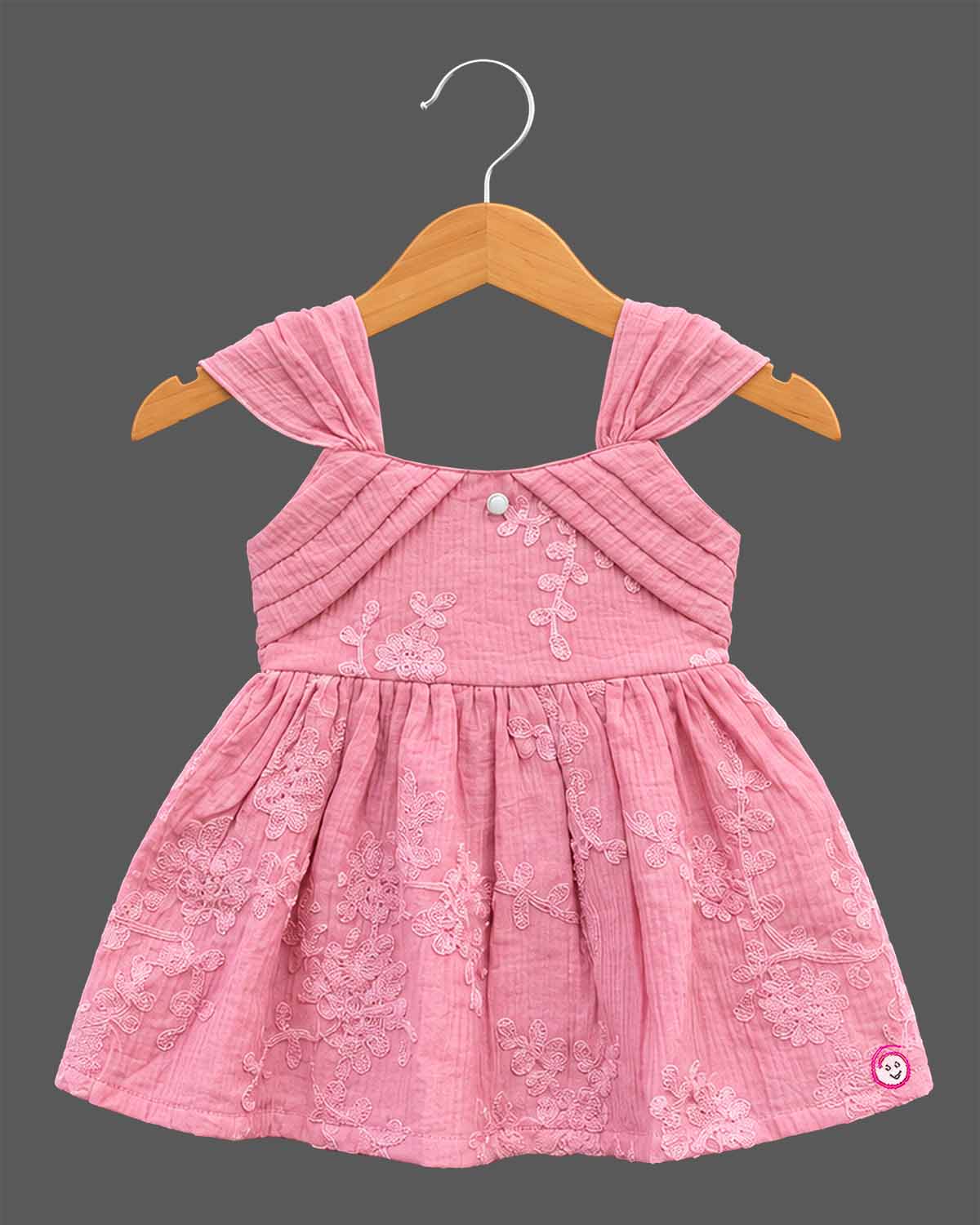 Toddler floral embroidered muslin frock with pleated cap shoulder straps and gathered A-line flared skirt.