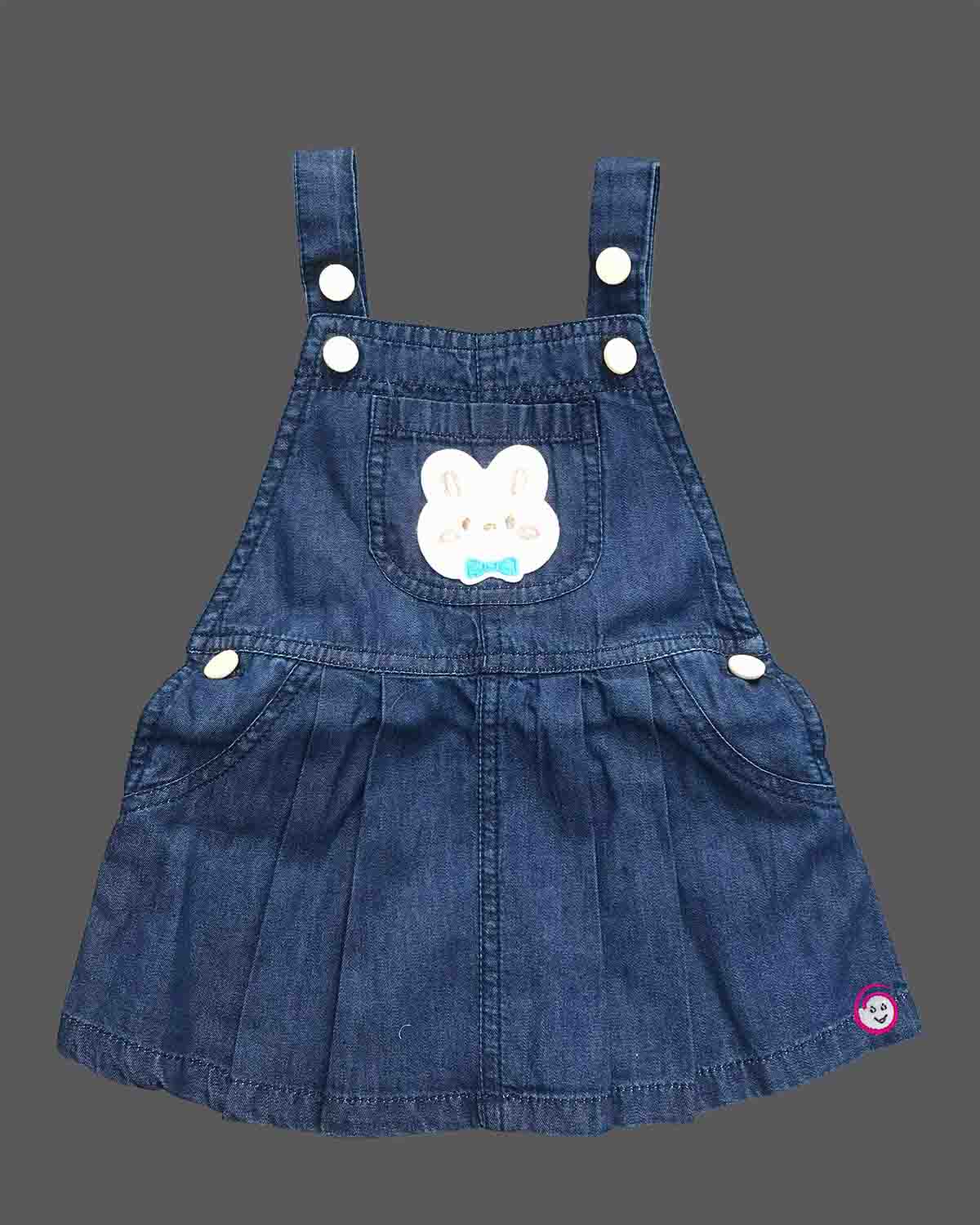 Toddler girl outfit set featuring textured puff sleeve blouse and denim pinafore dress with bunny patch detail and pleated skirt