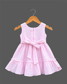 Sleeveless textured crinkle cotton frock with waist bow accent, lace trim, and tiered ruffle hemline for girls.