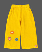 Embroidered peplum top and wide-leg pants co-ord set representing a kurti for kids with front button closures.