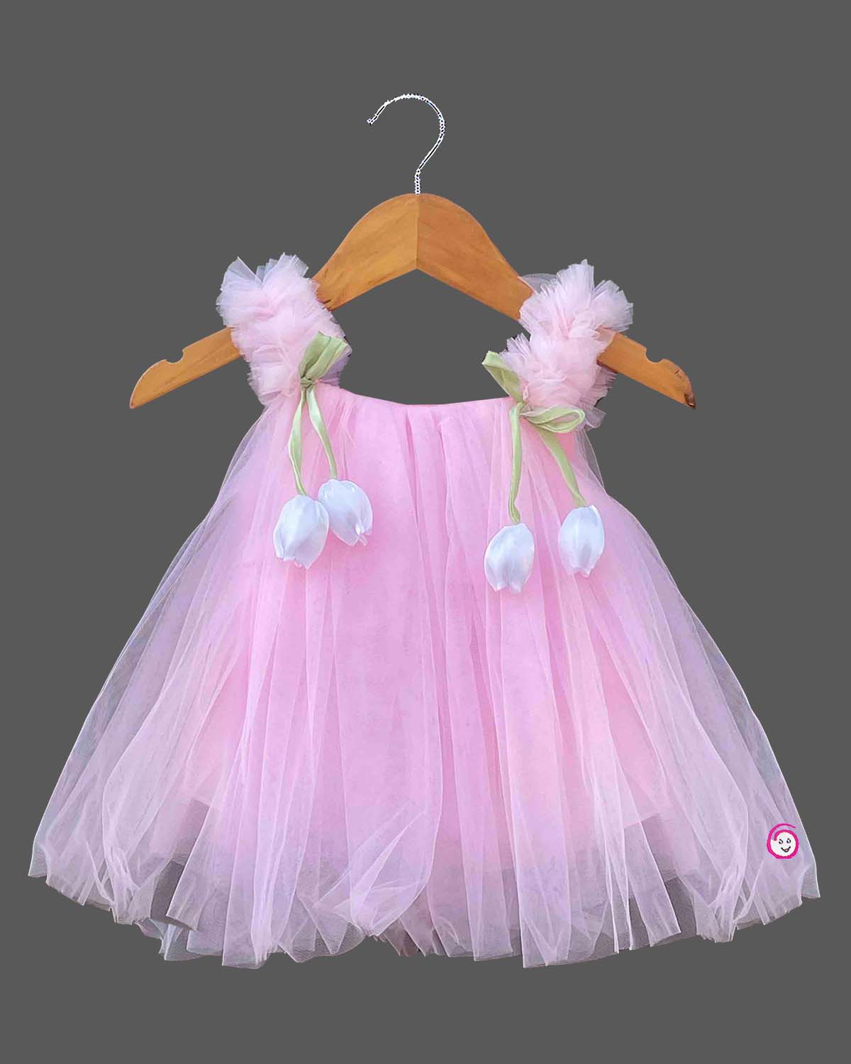Layered tulle flared silk frocks for baby girl featuring ruffled shoulder straps and dangling floral appliques.