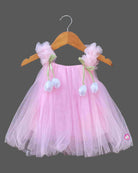 Layered tulle flared silk frocks for baby girl featuring ruffled shoulder straps and dangling floral appliques.