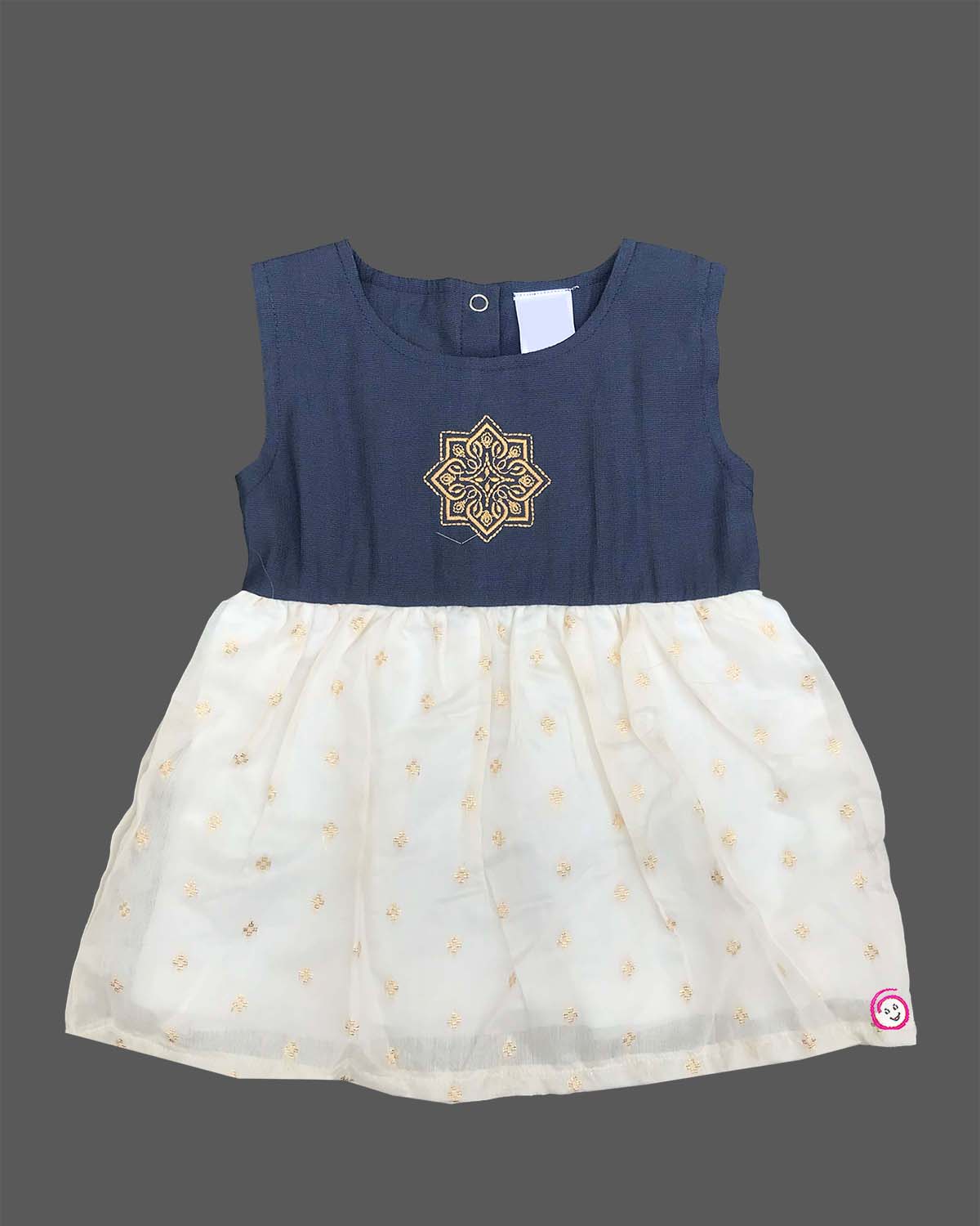 Traditional festive frock for baby girls featuring a sleeveless yoke with golden embroidery and a shimmering tissue skirt, perfect for Onam celebrations.